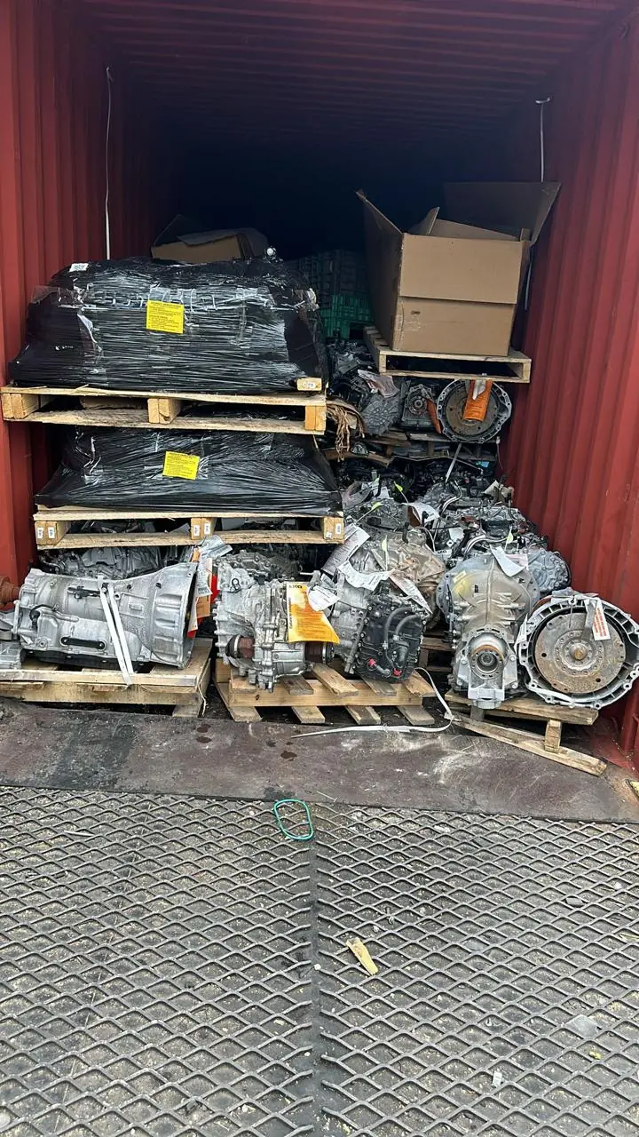 Entrance of a loaded container with pallets, transmissions and wrapped parts