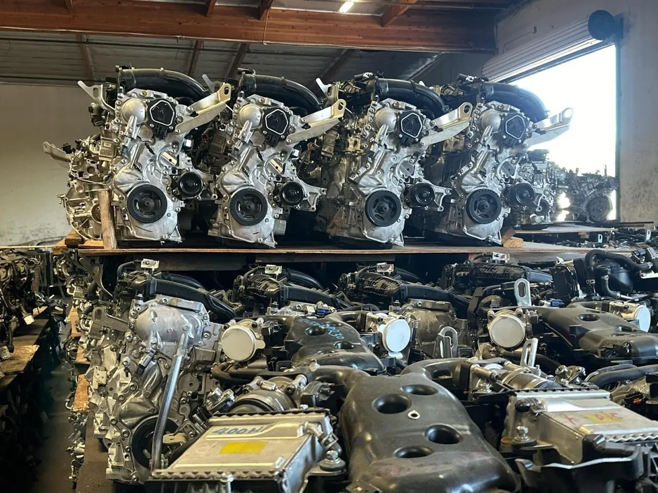 Different used automotive engines arranged on warehouse storage racks