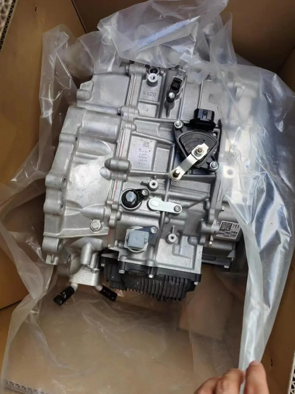 Transmission inside a cardboard box lined with protective plastic