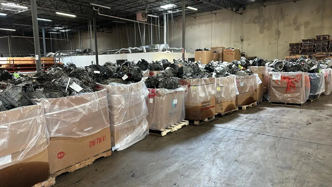 Large lined boxes of automotive parts arranged on pallets in a warehouse